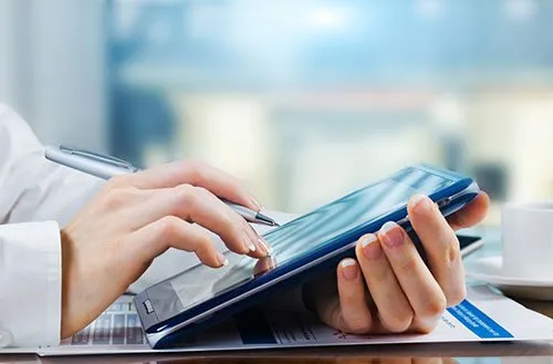 person using a tablet to enter patient registration info